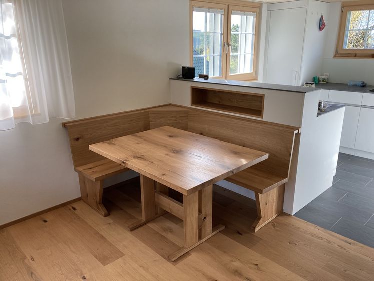 Moderne Küche mit Holzboden und Eckbank aus Holz.